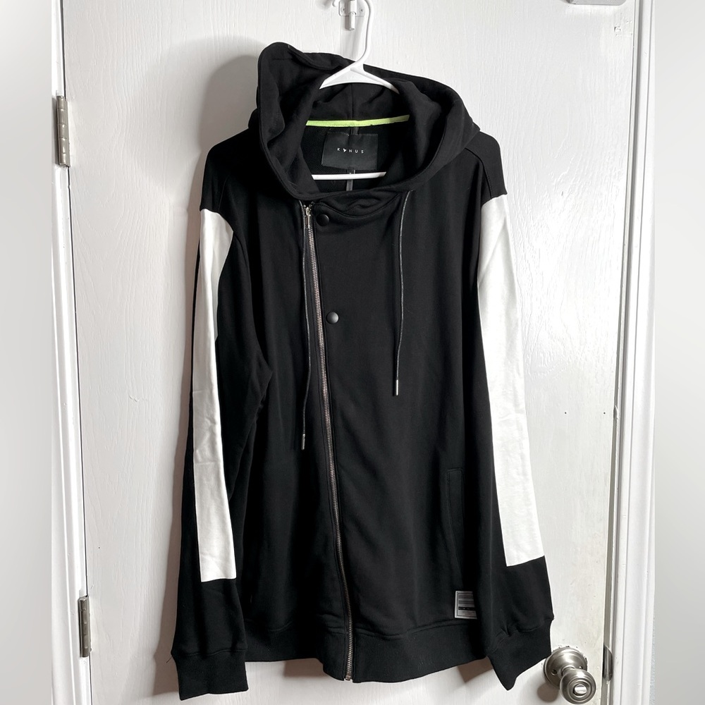 Konus brand asymmetrical zip up hoodie. Black with white patch down arm. Size XL